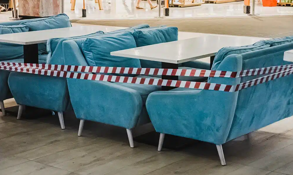 Booth Sets with arms in a open hallway, do-not-enter sign wrapped around them