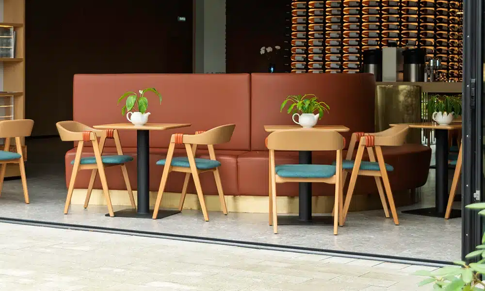 modern wood style cafe with curved banquette seating in a run with tables and chairs