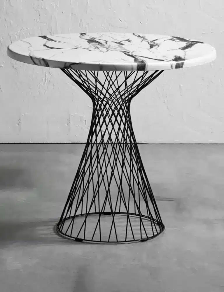 Outdoor table base supporting a commercial dining top on a terrace or patio.