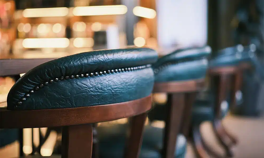 close up of an upholstered bar chair high stool in a pub setting