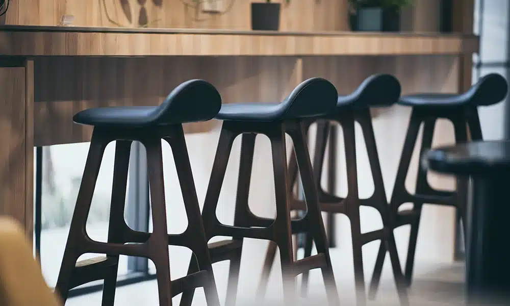 blue wooden bar stools at a bar in an industrial style bar