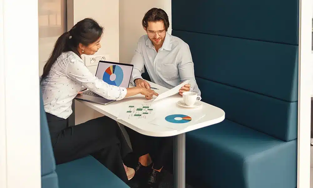 Large Meeting Pod with two office workers inside looking at documents, in an office environment