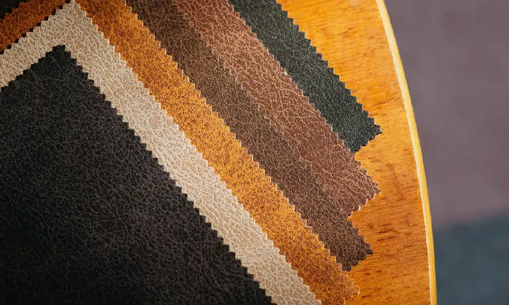 Distressed style faux leather swatch pieces laid out on a table