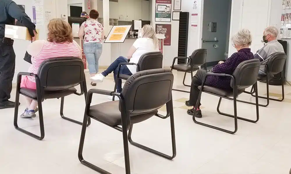 Metal chairs spread out in a UK healthcare clinic