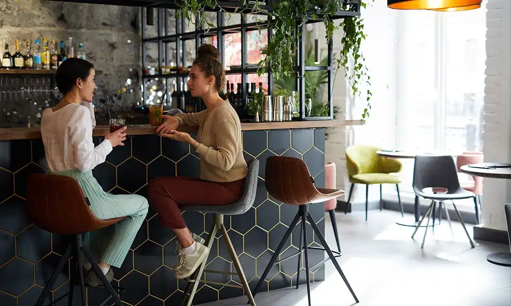 Luxurious bar stools in a modern hotel bar, dark distressed stlye upholstery