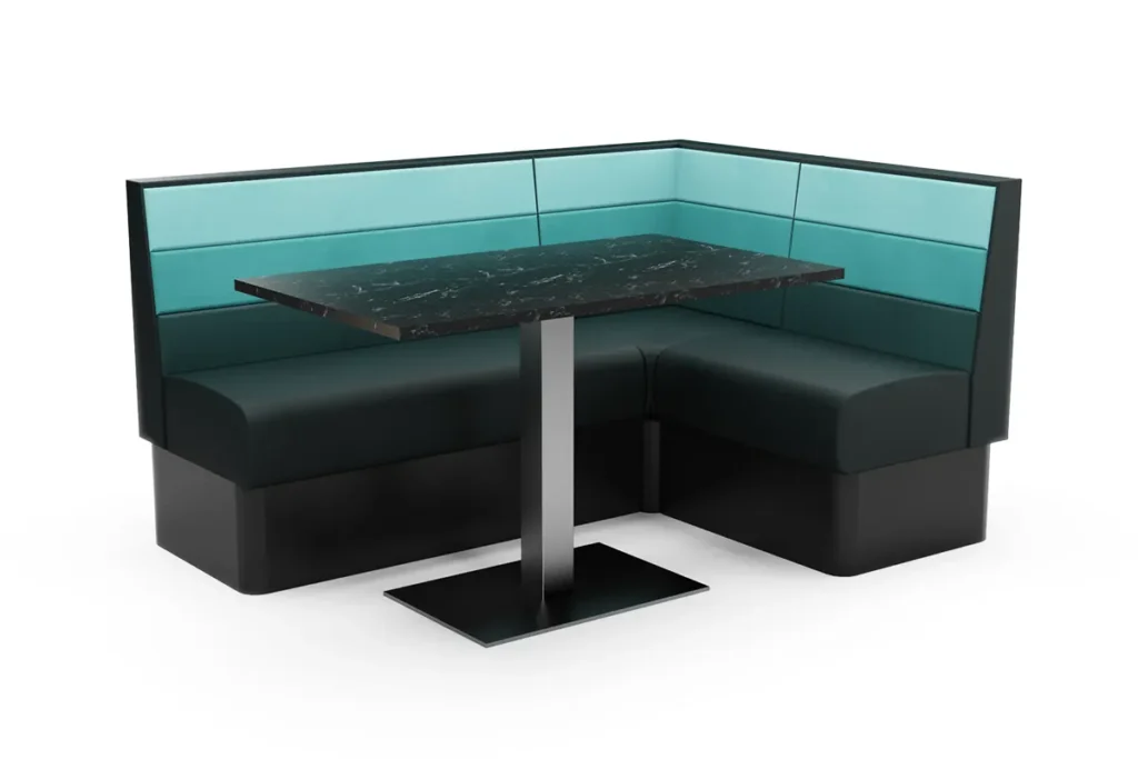 L-shaped corner booth seating with horizontal fluted upholstery and a marble dining table in front.