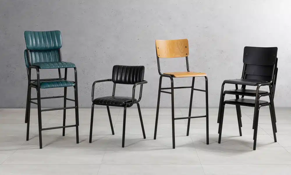 A group of various metal framed chairs in a line showing different colours and styles for commercial dining chairs