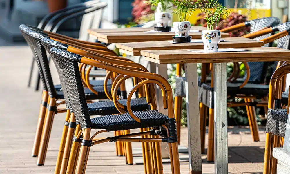 outdoor chairs and table on a pavement, black and aluminium modern style chairs
