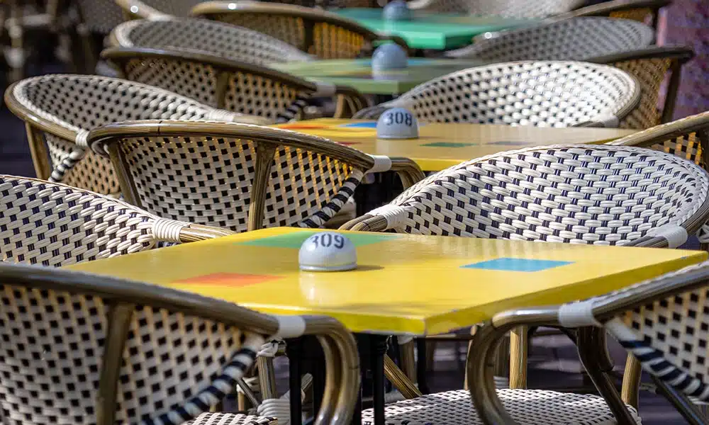 closeup of woven rattan aluminium chairs in an outdoor cafe area