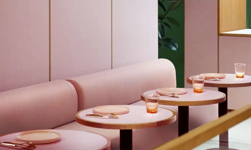 Pink plush velvet style booth seating in a bright pink restaurant