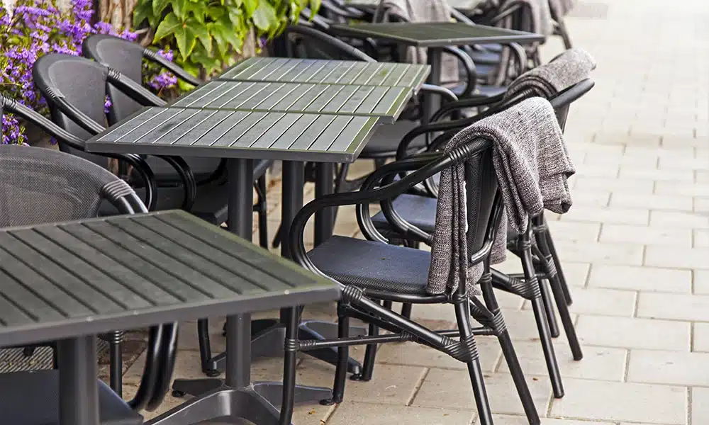 large metal aluminium table tops and chairs in a cafe exterior