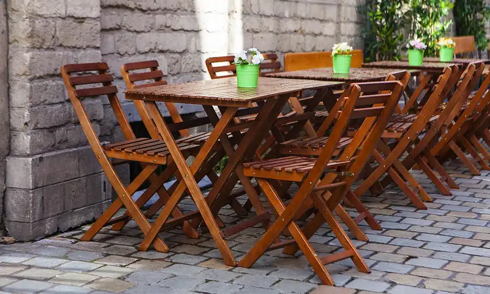 Rustic teak style chairs outside a commercial restaurant in the UK