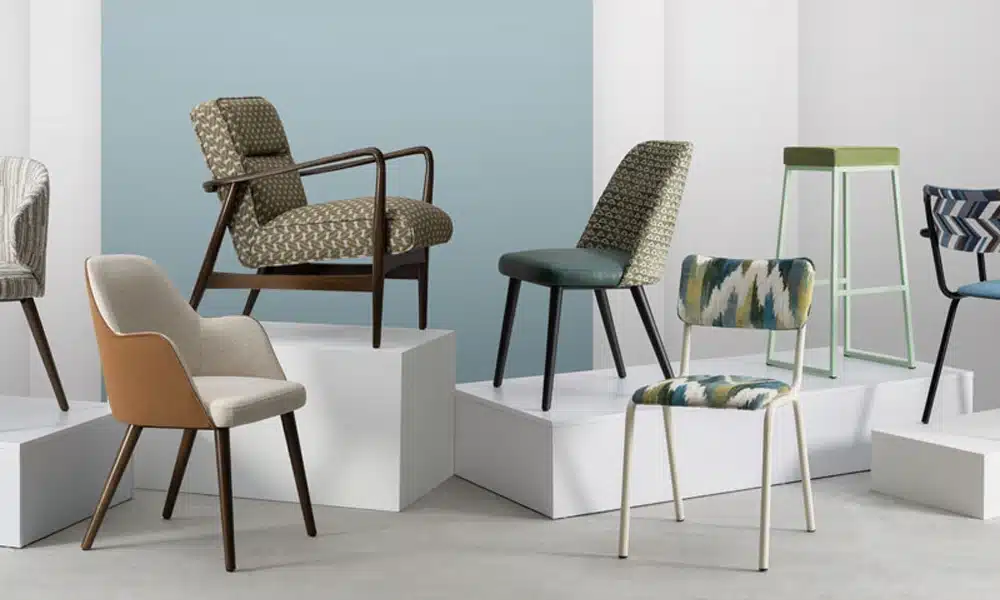 A studio shot of upholstered dining chairs with different upholstery colours and fabrics for commercial restaurants