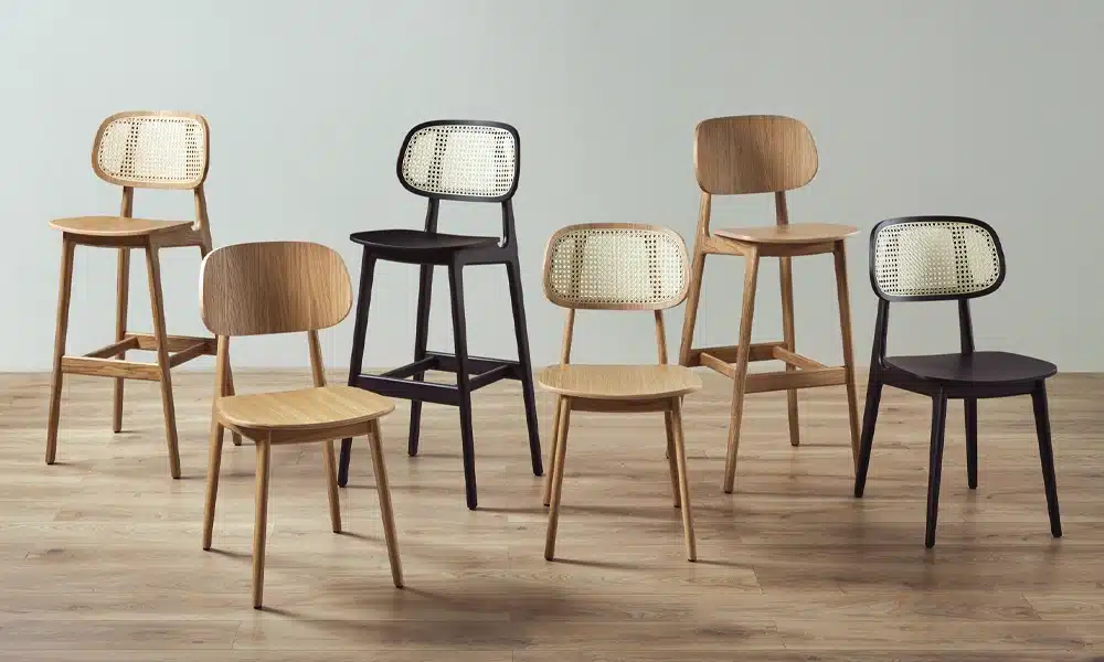 a row of wooden framed dining stools showing various stains and finishes for contract uses