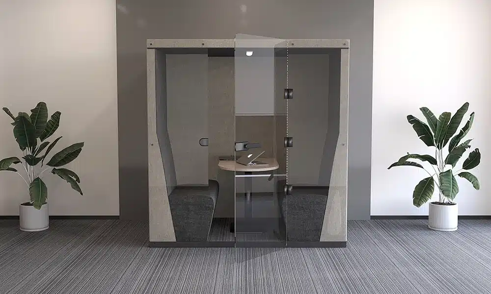 Glass front acoustic pod in an open plan modern office room, the glass door is slightly open revealing the inside of the pod