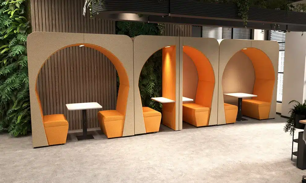 Large Nook Acoustic Pods in an office space, brightly lit room and internal lights light up the interior of the meeting pods