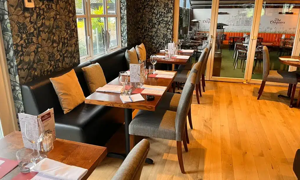 Pub lounge area with plain back booth seating along a wall