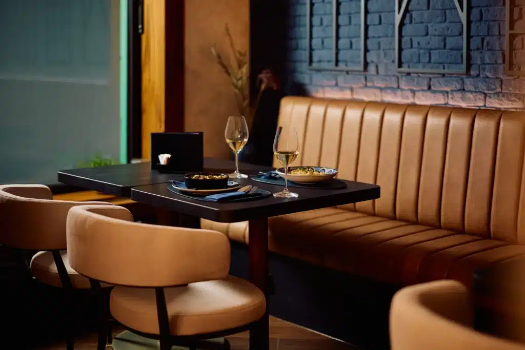 Orange faux leather banquette seating in a london commercial restaurant