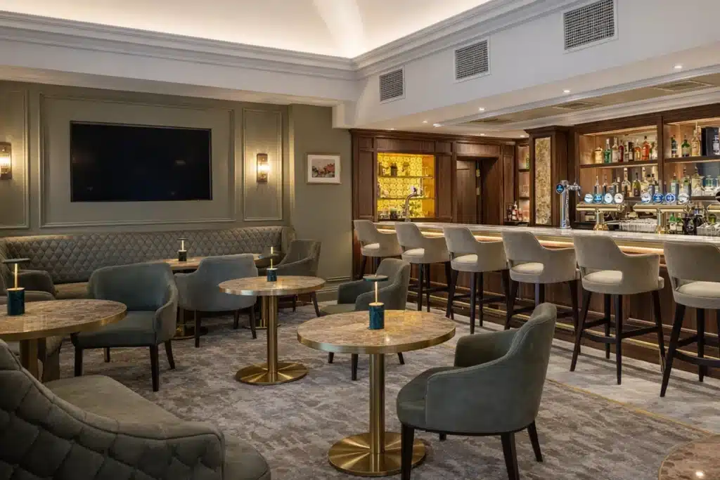 Luxury bar interior with plush seating and booth seating, gold table bases