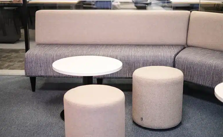 close up shot of serene booth seating made by HCF contract furniture, a coffee table and two stools are opposite